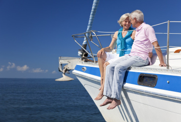 Happy Senior Couple Sitting on a Sail Boat
